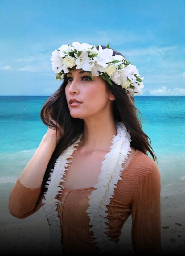 A traditional white and green Haku lei flower crown worn for a special occasion.