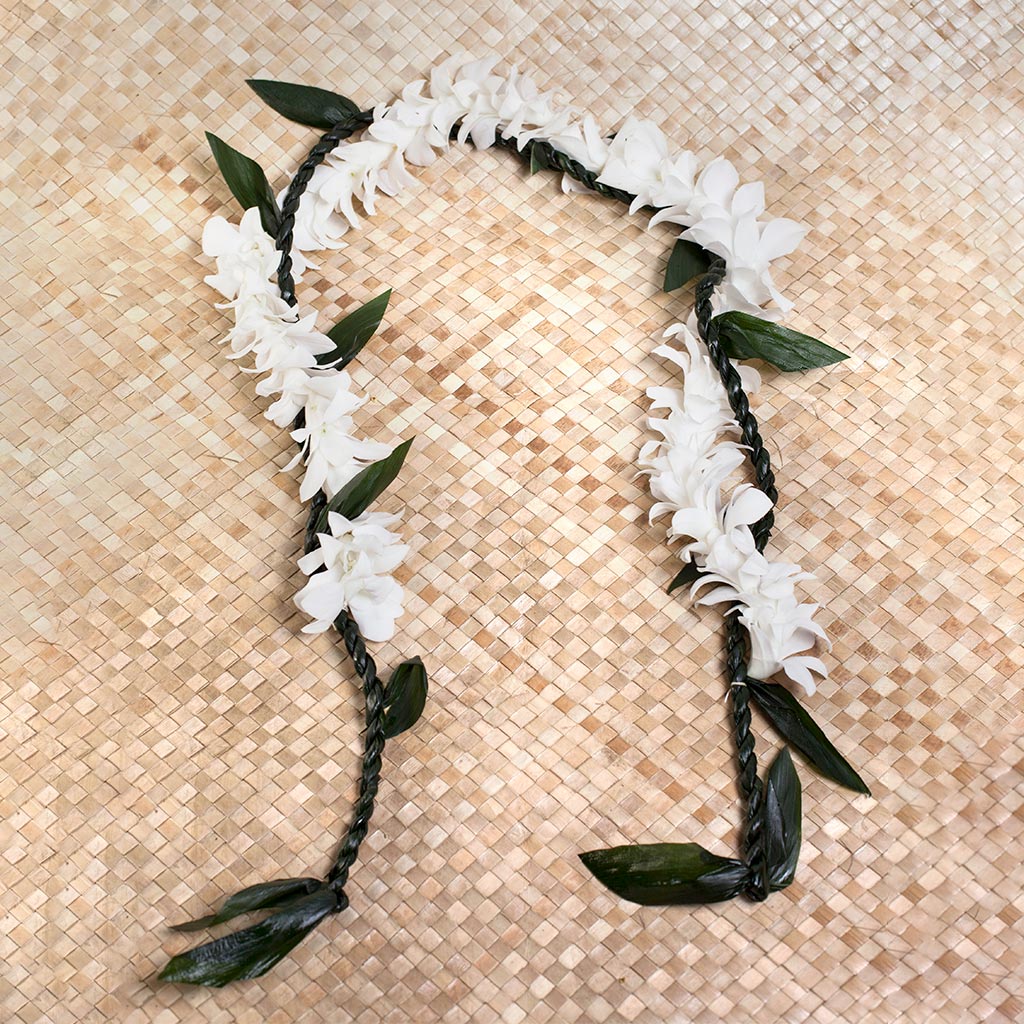 Traditional green ti leaf lei wrapped with orchid flowers