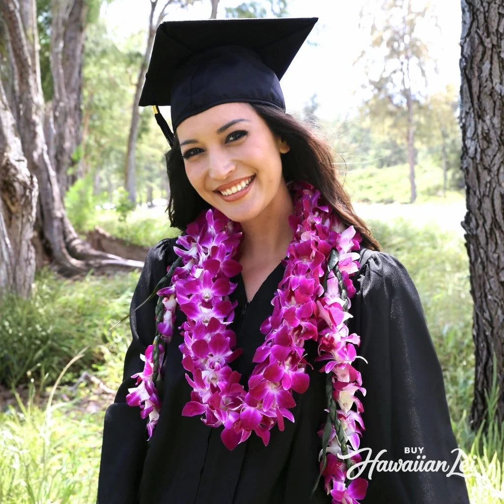 Graduate wearing a two-piece graduation lei set with ti leaf lei and double purple orchid lei