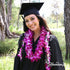 Graduate wearing a two-piece graduation lei set with ti leaf lei and double purple orchid lei