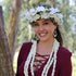 Woman wearing a handcrafted pikake three-strand lei and white orchid haku flower crown in Hawaii