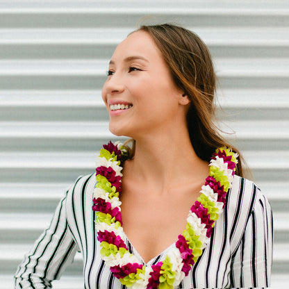 Spiral orchid lei using white, green, and purple flowers